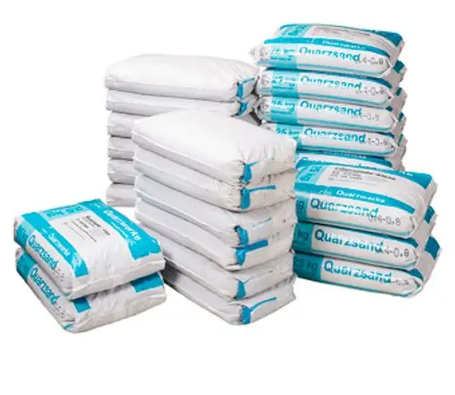 Stapel von Säcken mit Filterfüllung, beschriftet mit "Quarzsand", zur Verwendung in Filtersystemen, hergestellt von Grünbeck.